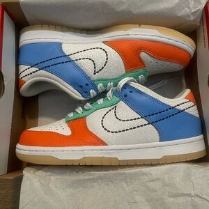 Nike Dunk Low GS in White, Black, and Safety Orange